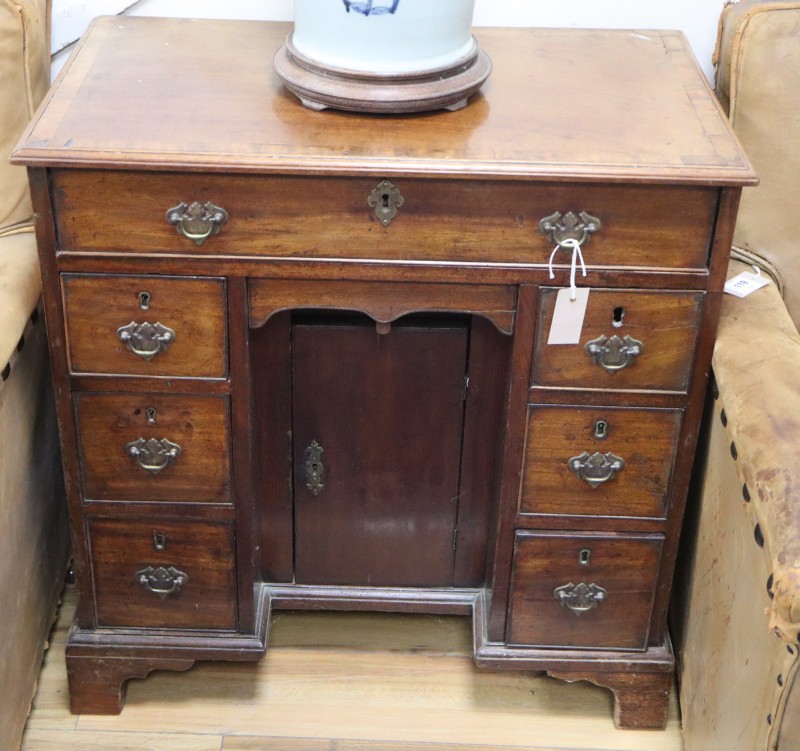 A George III mahogany kneehole desk, W.75cm., D.44cm., H.77cm.